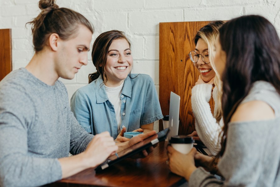 Two people meeting safely in a public cafe